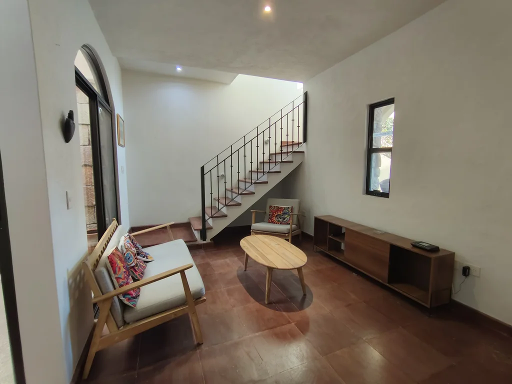 Living room with staircase, natural light
