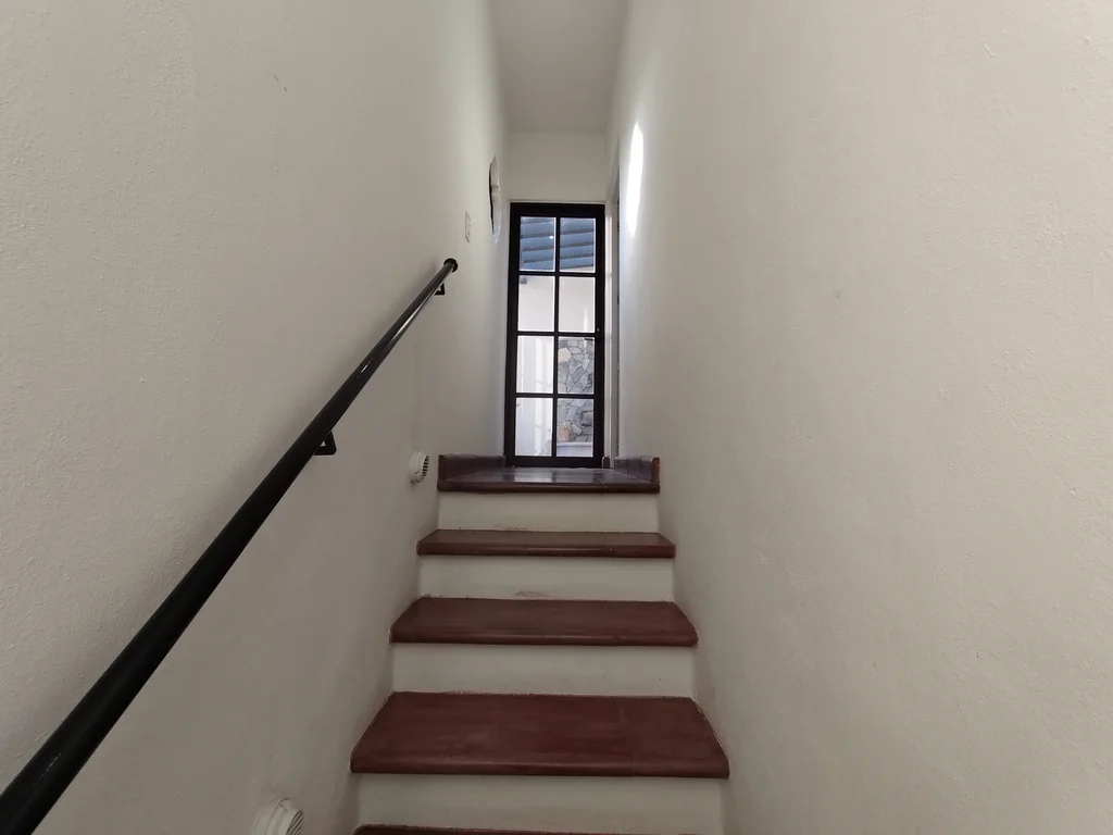 Interior staircase connecting the downstairs and upstairs